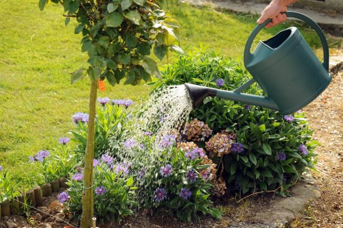 Satisfied homeowner enjoying a well-maintained garden in Hampstead